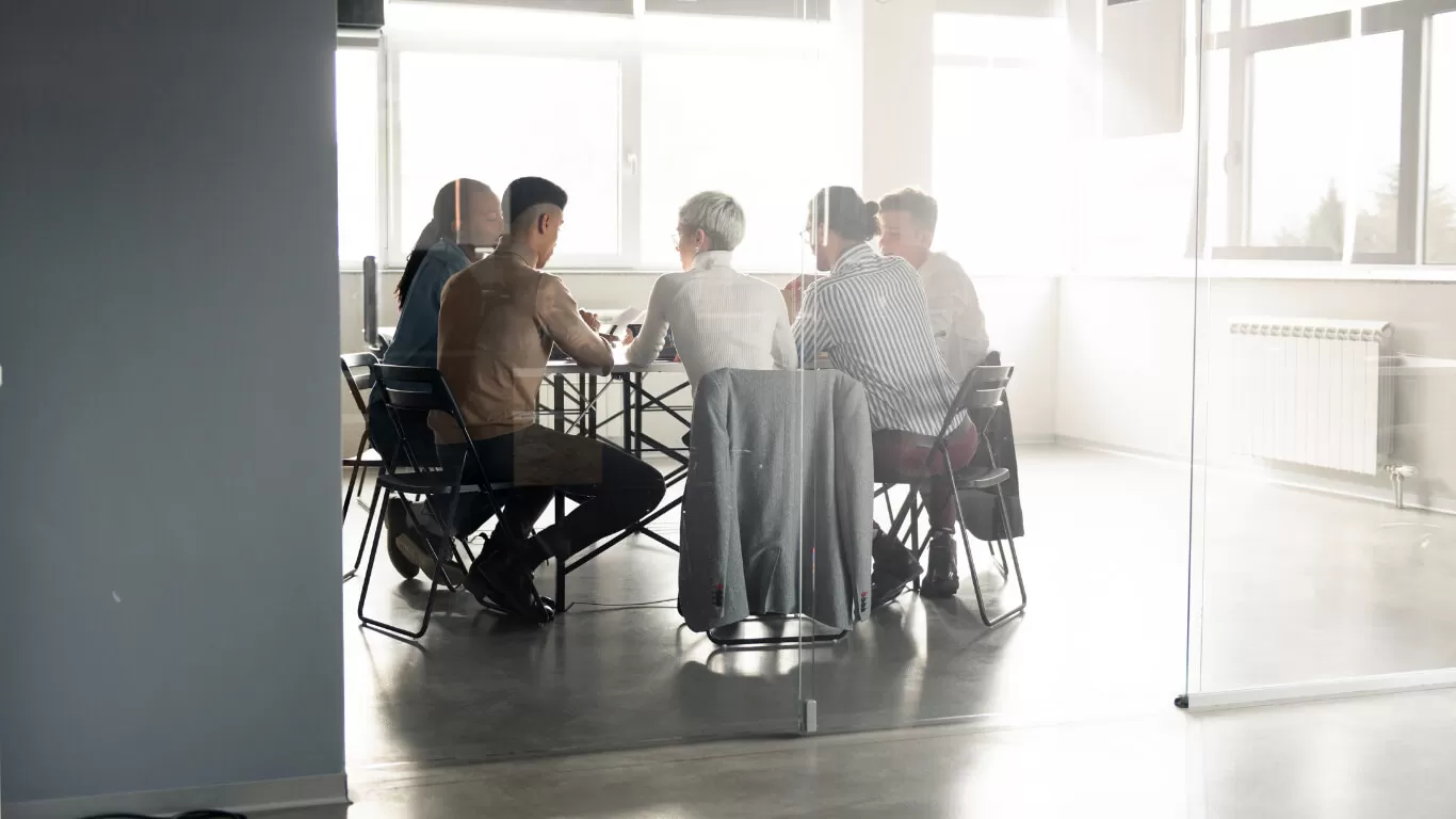 Group of professionals in a meeting room discussing technology solutions for CPA firms, highlighting collaboration and modern business practices.