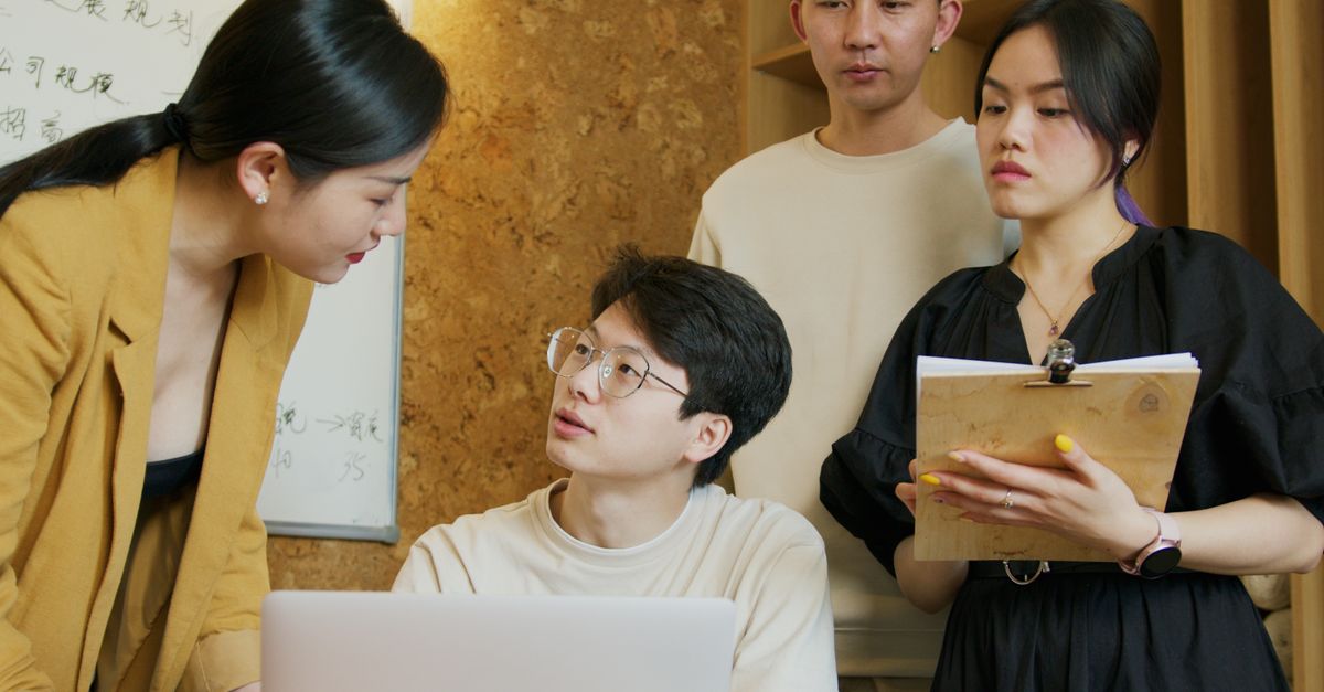A group of professionals exchanging ideas during a business meeting indoors.