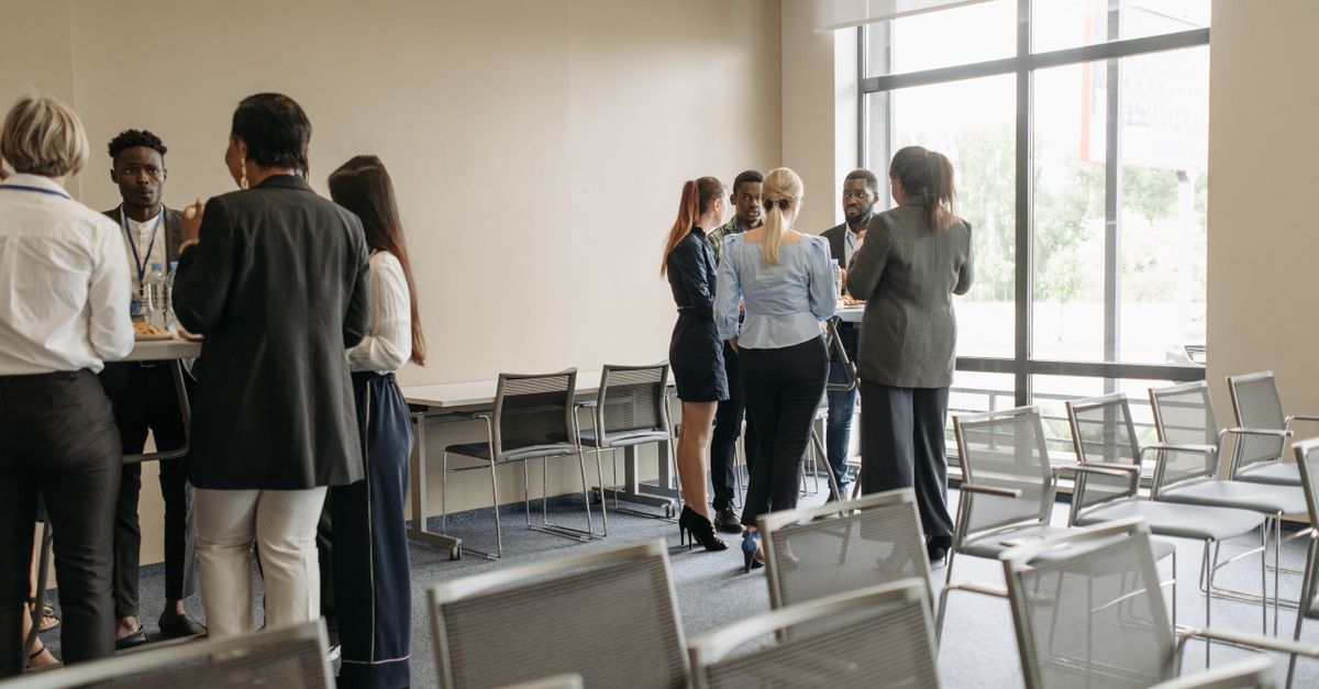 Professionals engaging in a casual networking session during a business conference.