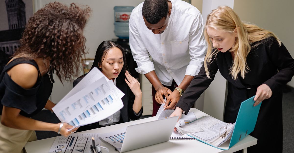 A diverse team of professionals engaged in a collaborative meeting at a modern office space.