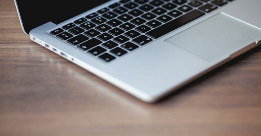 A sleek laptop on a wooden surface, showcasing elegant design and technology.