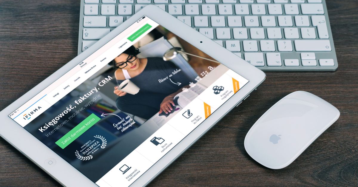 A tablet with a financial website open, alongside a white keyboard and mouse. Ideal for tech-theme stock images.