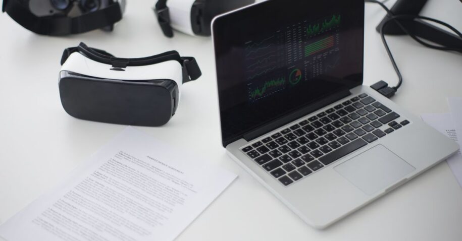 Modern workspace featuring laptop and VR headsets, ideal for tech themes.