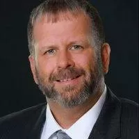 Frank V., PracticeERP team member, smiling in professional attire, emphasizing leadership in ERP solutions and client-focused productivity.